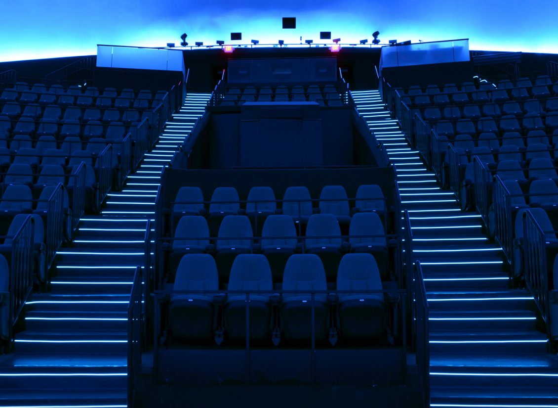 Dark blue lighted theater stairs in the Science Museum of Virginia